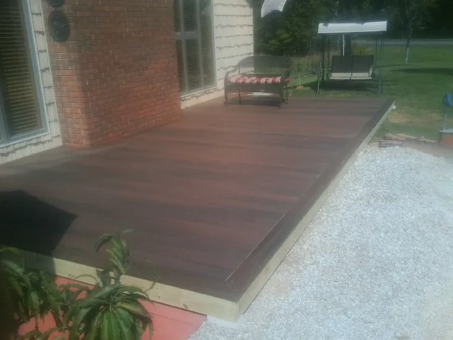 Freshly stained wood deck built against a brick home in Lewistown